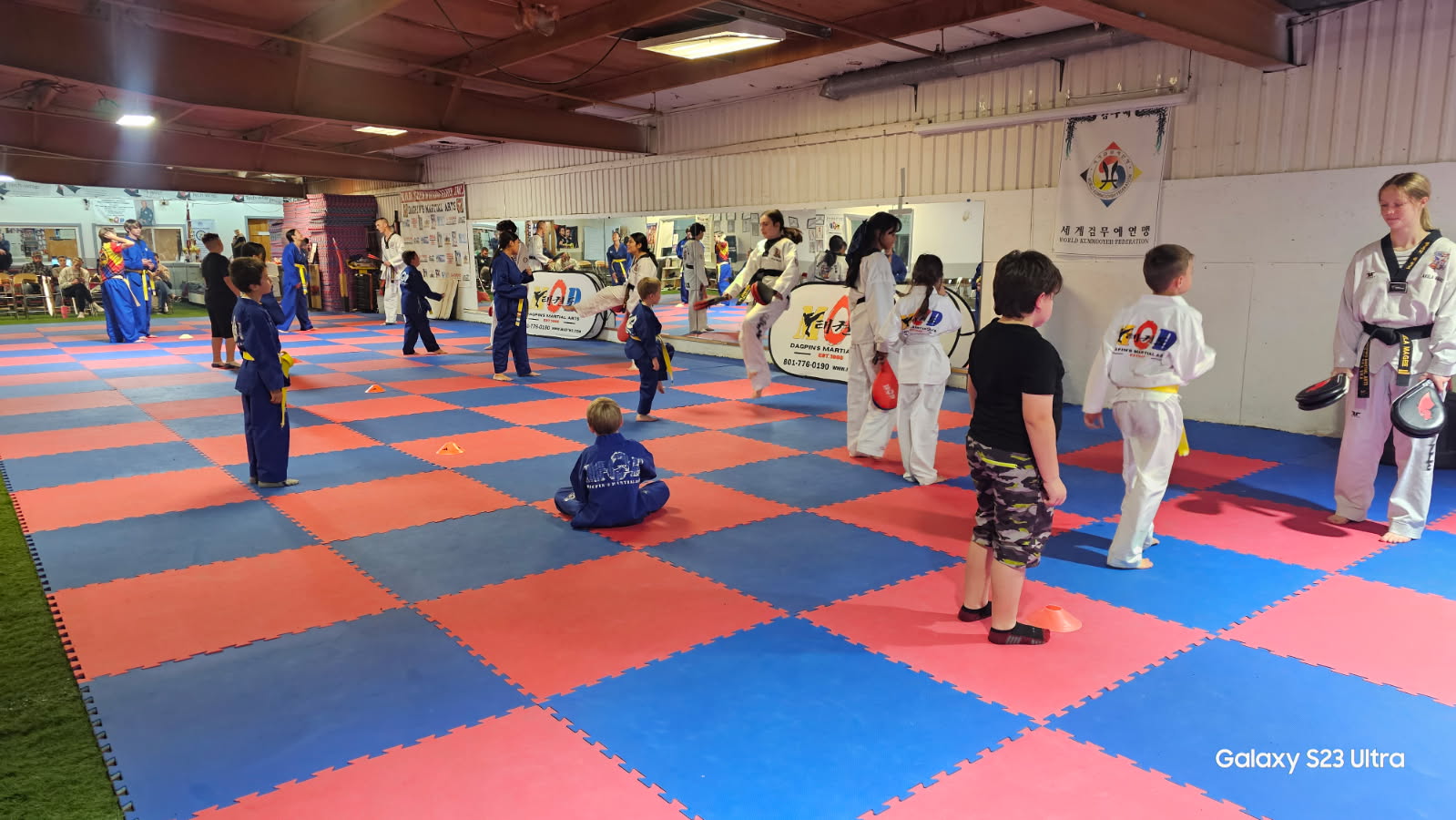 Kids practicing kicking drills with instructors during a class at MOD Taekwondo North Ogden